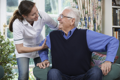 caregiver assisting elder man
